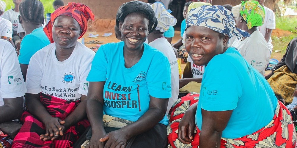 Woman sitting outside in a group.