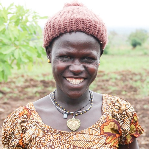 Woman in knit hat smiling on camera.