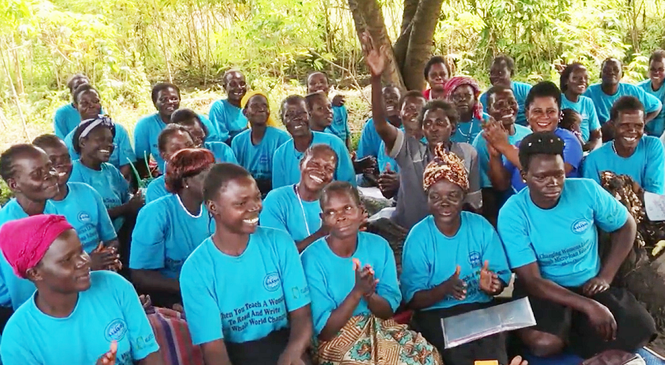 Group of Ugandan women seated outside.