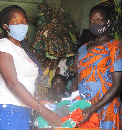 Women standing with box of masks.