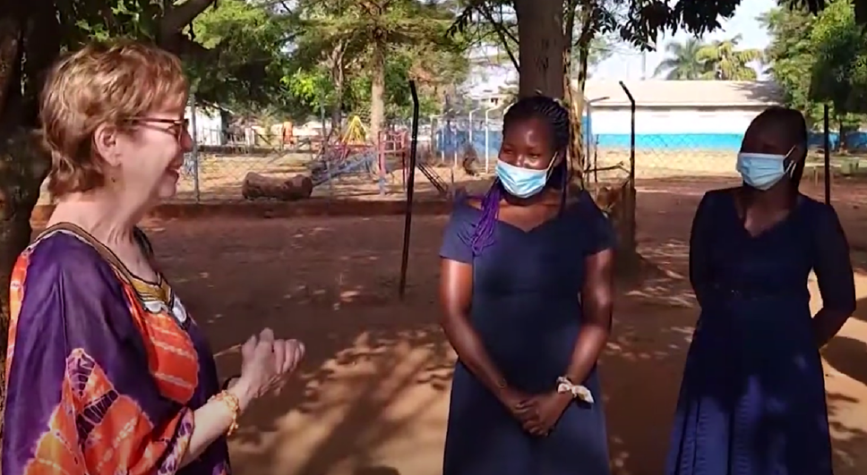 Karon standing with Ugandan women